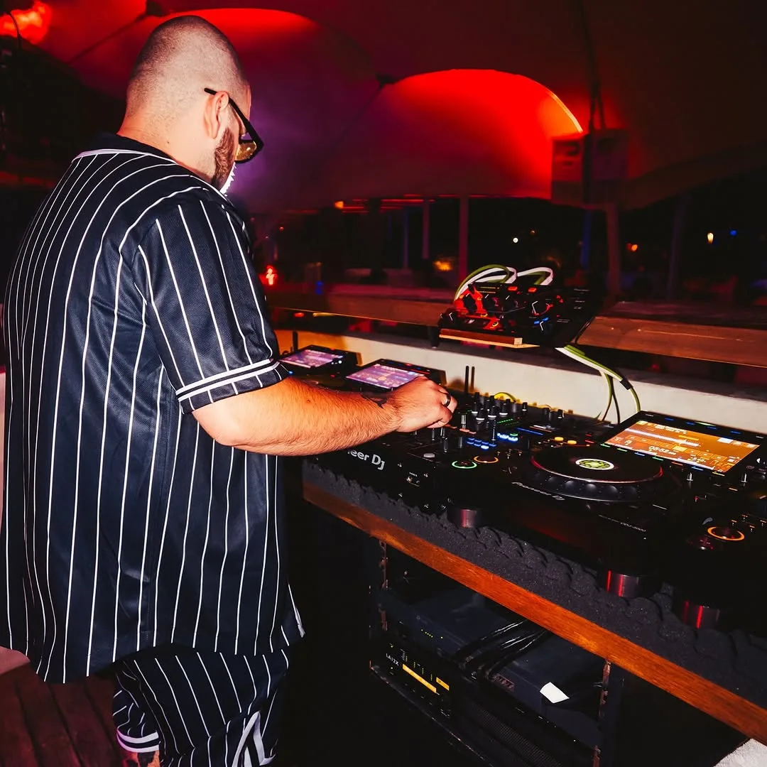 CHASA at the controls in a wide club booth