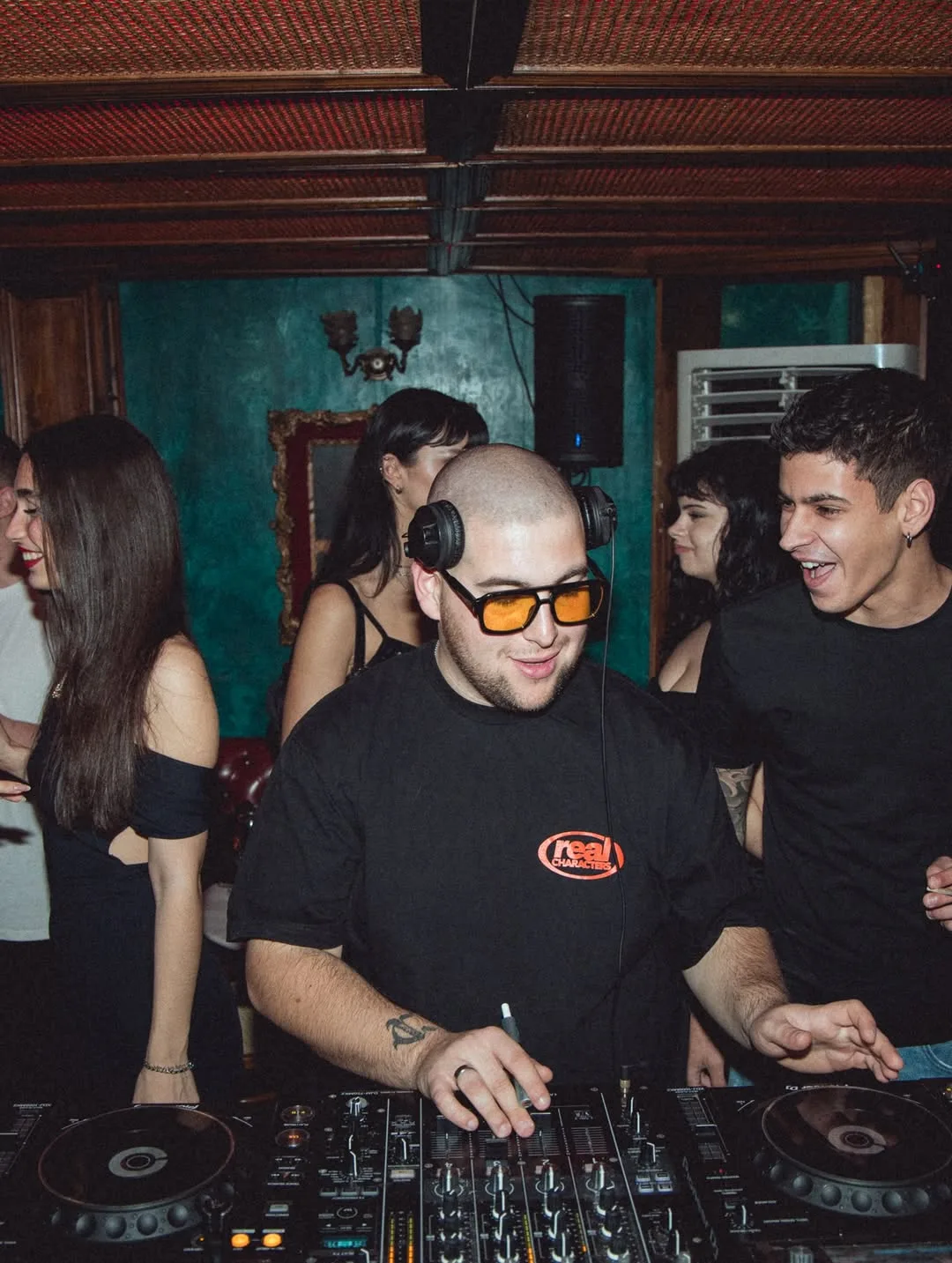 CHASA behind the decks in a warm, crowded room
